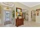 Bright and spacious entryway with decorative furniture and large mirror at 2619 Myakka Marsh Ln, Port Charlotte, FL 33953