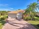 Beautiful home with tile driveway, two-car garage, and lush landscaping at 2619 Myakka Marsh Ln, Port Charlotte, FL 33953