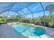 Enjoy this refreshing kidney-shaped pool and spa with screened enclosure at 2619 Myakka Marsh Ln, Port Charlotte, FL 33953