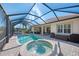 Private pool and spa with covered patio and plenty of seating at 2619 Myakka Marsh Ln, Port Charlotte, FL 33953