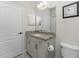 Bathroom with granite countertop vanity and updated fixtures at 26744 Weiskopf Dr, Englewood, FL 34223