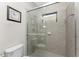 Clean bathroom with a large walk-in shower and tile surround at 26744 Weiskopf Dr, Englewood, FL 34223