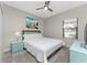 Guest bedroom with full-size bed, light teal accents, and window coverings at 26744 Weiskopf Dr, Englewood, FL 34223