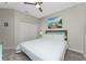 Guest bedroom with a full-size bed and light teal decor at 26744 Weiskopf Dr, Englewood, FL 34223