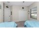 Spacious bedroom with twin beds, light blue bedding, and ample closet space at 26744 Weiskopf Dr, Englewood, FL 34223