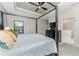 Spacious main bedroom with a large bed, dresser, and ensuite bathroom access at 26744 Weiskopf Dr, Englewood, FL 34223