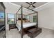 Spacious main bedroom with a king-size bed and tray ceiling at 26744 Weiskopf Dr, Englewood, FL 34223