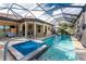 Large pool and spa with covered patio and grill at 26744 Weiskopf Dr, Englewood, FL 34223