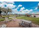 Brick patio furniture and a canal view with palm trees in the backyard at 276 Long Meadow Ln, Rotonda West, FL 33947