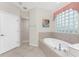 Bathroom boasts an oval soaking tub, walk-in shower, and a large window at 276 Long Meadow Ln, Rotonda West, FL 33947