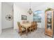 Formal dining room with wooden table and chairs, plus a large window at 276 Long Meadow Ln, Rotonda West, FL 33947