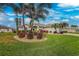 Landscaped front yard with palm trees and manicured lawn at 276 Long Meadow Ln, Rotonda West, FL 33947