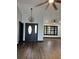 Modern entryway with dark hardwood floors and a chandelier at 294 Rotonda Cir, Rotonda West, FL 33947