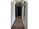 Long hallway with dark trim and wood-look flooring at 294 Rotonda Cir, Rotonda West, FL 33947