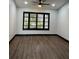 Spacious living room featuring dark hardwood floors and plantation shutters at 294 Rotonda Cir, Rotonda West, FL 33947