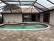 Kidney-shaped pool with covered patio at 294 Rotonda Cir, Rotonda West, FL 33947