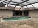 Kidney-shaped pool with covered patio at 294 Rotonda Cir, Rotonda West, FL 33947