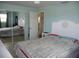 Spacious bedroom with mirrored closet doors and ensuite bathroom access at 3159 Pinetree St, Port Charlotte, FL 33952