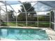 Refreshing screened pool with ample space for swimming and lounging at 3159 Pinetree St, Port Charlotte, FL 33952