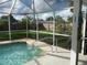 Inviting screened pool area with grassy backyard at 3159 Pinetree St, Port Charlotte, FL 33952