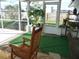 Relaxing screened porch with rocking chairs and lush plants at 3159 Pinetree St, Port Charlotte, FL 33952