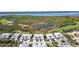 Community aerial view showcasing well-maintained condo buildings, a waterway, and a golf course at 3323 Grand Vista Ct # 201, Port Charlotte, FL 33953