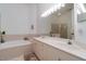 Bright bathroom features a double sink vanity, a soaking tub and tile accents at 3323 Grand Vista Ct # 201, Port Charlotte, FL 33953