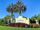 Welcoming entrance sign to Riverwood, a deed-restricted community, with lush landscaping at 3323 Grand Vista Ct # 201, Port Charlotte, FL 33953