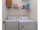 Convenient laundry room with a washer, dryer and a storage shelf at 3323 Grand Vista Ct # 201, Port Charlotte, FL 33953