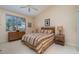 Well-lit main bedroom features a ceiling fan and charming bedside tables at 3323 Grand Vista Ct # 201, Port Charlotte, FL 33953