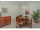 Wicker chairs surround a glass-top table in this charming dining room at 3353 Grand Vista Ct # 202, Port Charlotte, FL 33953