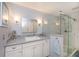 Bathroom with walk-in shower, vanity, and granite countertop at 367 Englewood Isles Pkwy # 4, Englewood, FL 34223