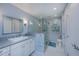 Updated bathroom with walk-in shower and gray tile at 367 Englewood Isles Pkwy # 4, Englewood, FL 34223