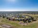 Expansive aerial view of house in a golf community with lush surroundings and water features at 40 Bunker Pl, Rotonda West, FL 33947