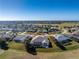 Aerial view of home showcasing the screened in patio backing onto a golf course at 40 Bunker Pl, Rotonda West, FL 33947