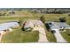 An aerial view shows the home's well-maintained landscaping, long driveway, and location between other residences at 40 Bunker Pl, Rotonda West, FL 33947