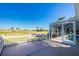 View of the back patio with access to a screened-in lanai overlooking a golf course at 40 Bunker Pl, Rotonda West, FL 33947