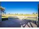 View of the back patio with access to a large green golf course beyond the bright white fence at 40 Bunker Pl, Rotonda West, FL 33947