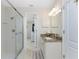 Well-lit bathroom featuring a granite countertop vanity and glass-enclosed walk-in shower at 40 Bunker Pl, Rotonda West, FL 33947