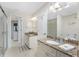 Well-lit bathroom with dual granite countertop vanities and walk-in shower at 40 Bunker Pl, Rotonda West, FL 33947