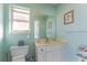 Bright bathroom with blue walls, a vanity with storage, and framed seashell art at 40 Bunker Pl, Rotonda West, FL 33947