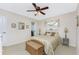 Cozy bedroom with a ceiling fan, comfortable bed, and natural light at 40 Bunker Pl, Rotonda West, FL 33947