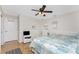 Bedroom featuring hardwood flooring, two twin beds, a ceiling fan, and a white dresser at 40 Bunker Pl, Rotonda West, FL 33947