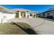 The front exterior of the home features a well-maintained lawn, a long driveway, and an attached two-car garage at 40 Bunker Pl, Rotonda West, FL 33947