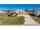 Beautiful home featuring an extended driveway and lush landscaping at 40 Bunker Pl, Rotonda West, FL 33947