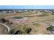 Aerial view of a scenic golf course surrounded by lush greenery and mature palm trees at 40 Bunker Pl, Rotonda West, FL 33947