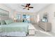 Spacious main bedroom with neutral tones, ceiling fan, and sliding glass door at 40 Bunker Pl, Rotonda West, FL 33947