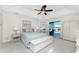 Spacious main bedroom with neutral tones, ceiling fan, and view to the pool at 40 Bunker Pl, Rotonda West, FL 33947