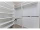 Spacious walk-in closet with multiple shelves and hanging rods for optimal storage at 40 Bunker Pl, Rotonda West, FL 33947