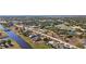 Aerial view of a canal front residential neighborhood in a sunny location at 411 Boundary Blvd, Rotonda West, FL 33947